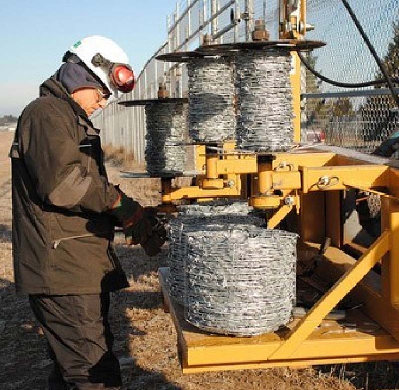 man preparing a steel fence